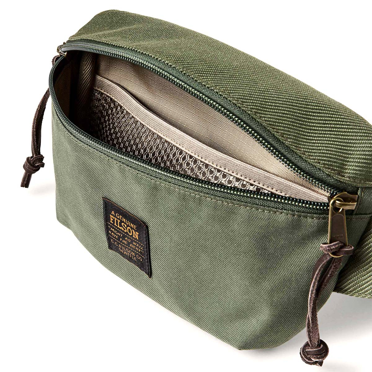 Filson Surveyor Crossbody Pack Service Green, Innen mit leichtem Ripstop-Nylon gefüttert und mit einer Netztrennwand versehen